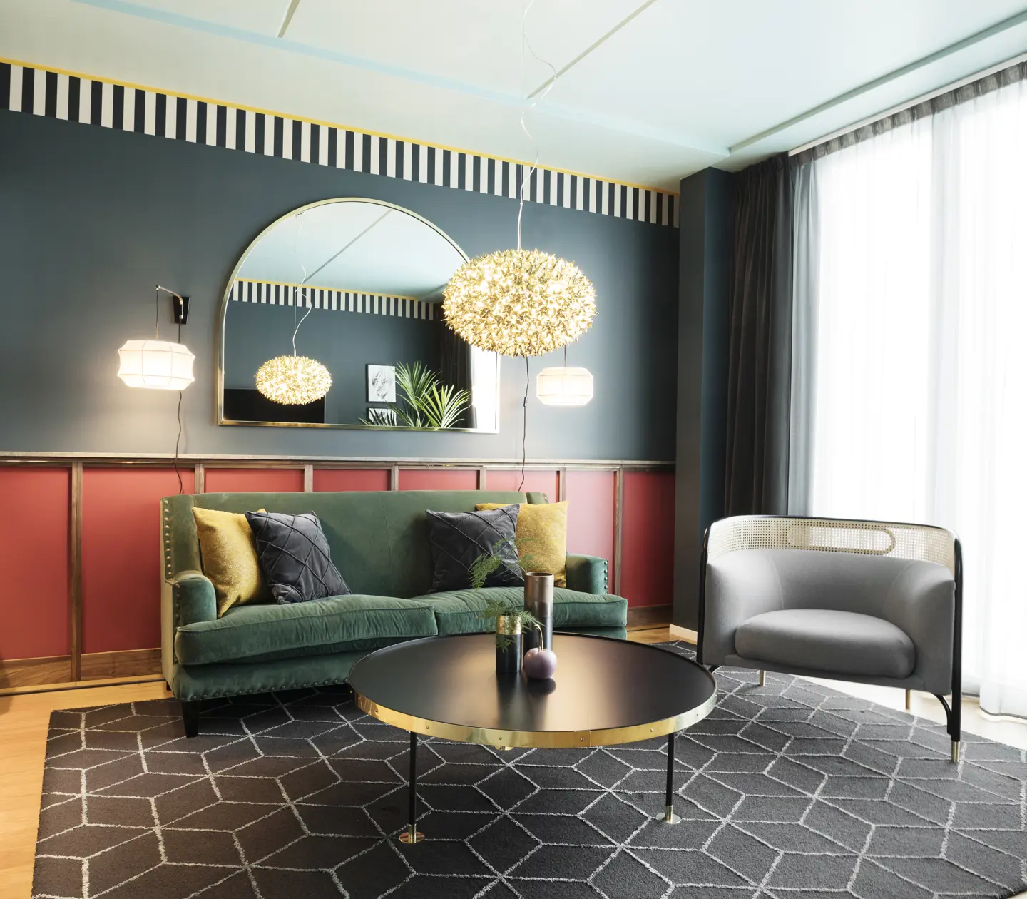 Cozy suite with blue and red walls, sofa group and mirror