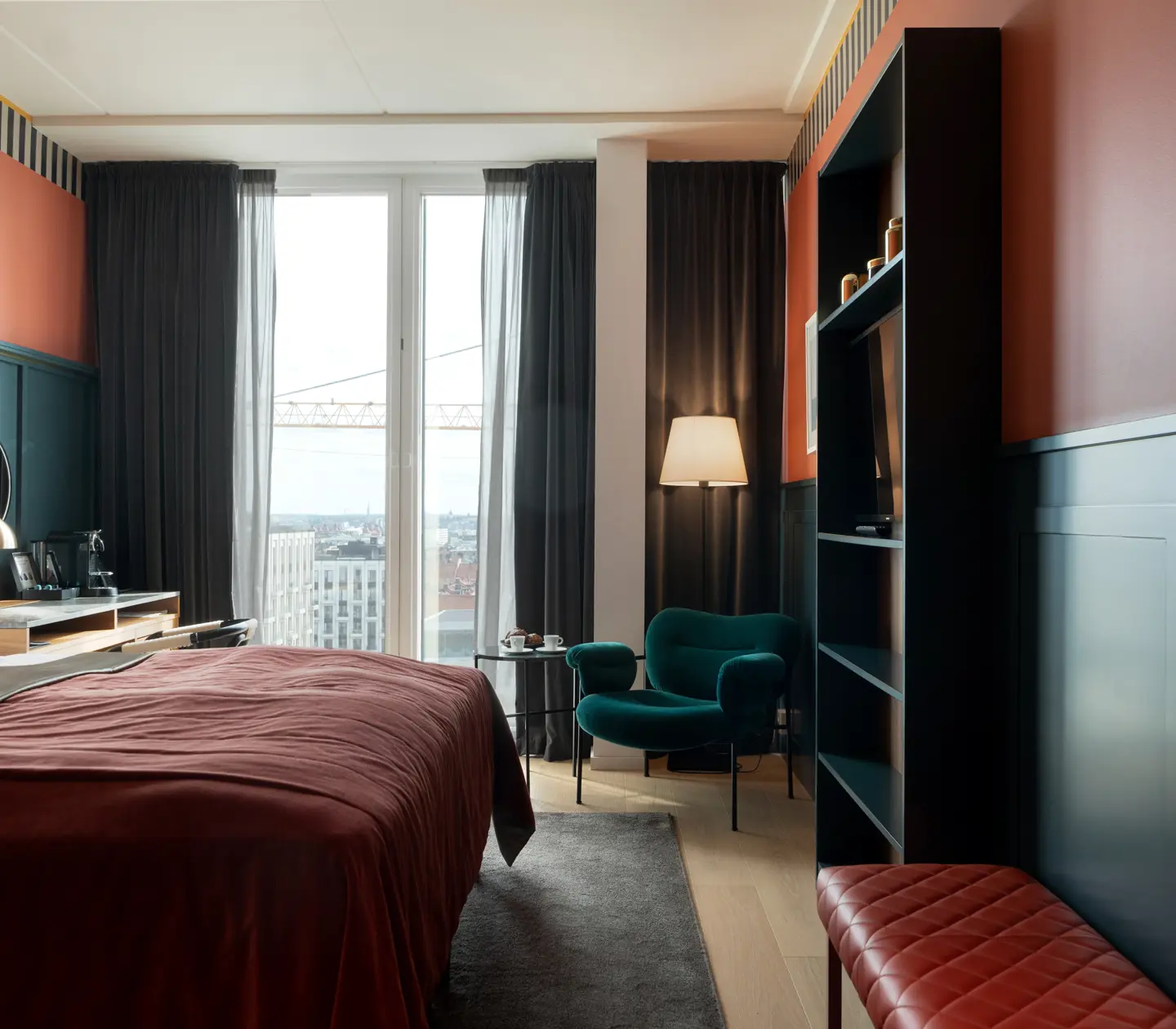 Cozy suite with blue and red wall, bed and bookshelf