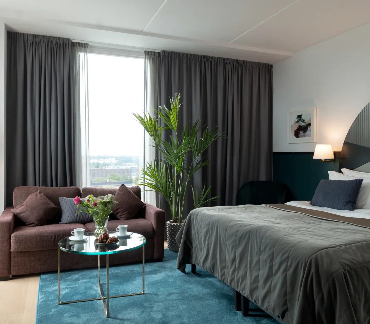 Bright suite with bed, colorful headboard and sofa