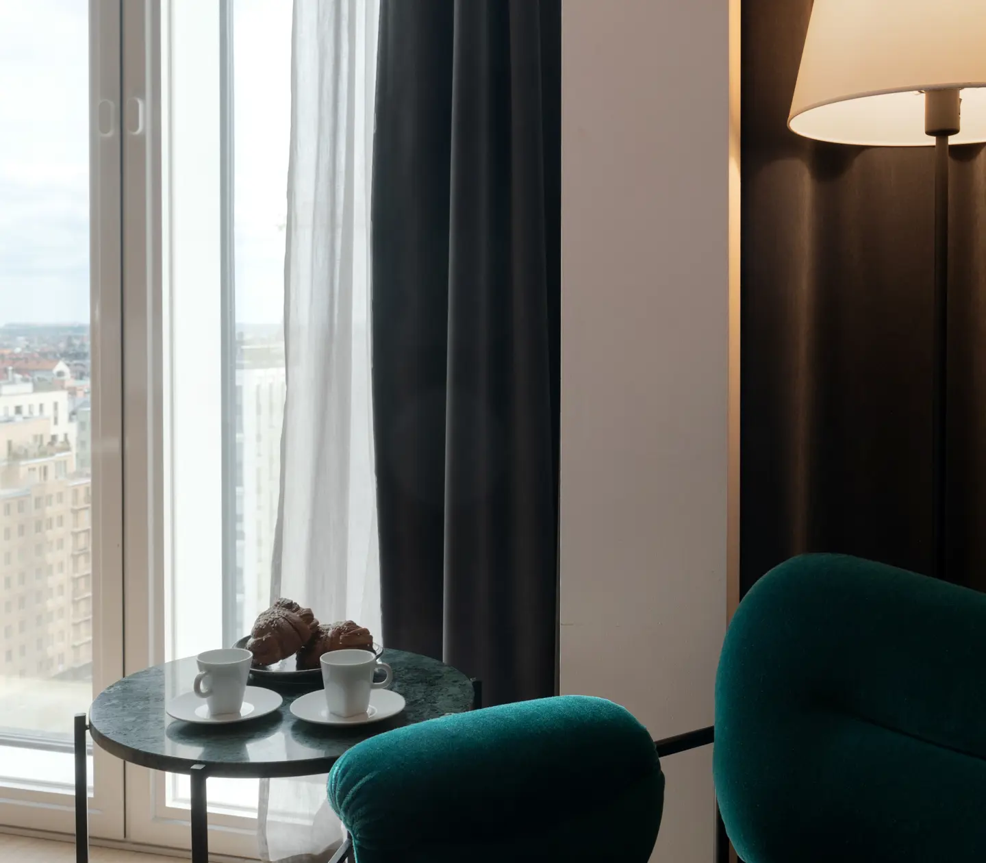 Bright suite with armchair, coffee and large window