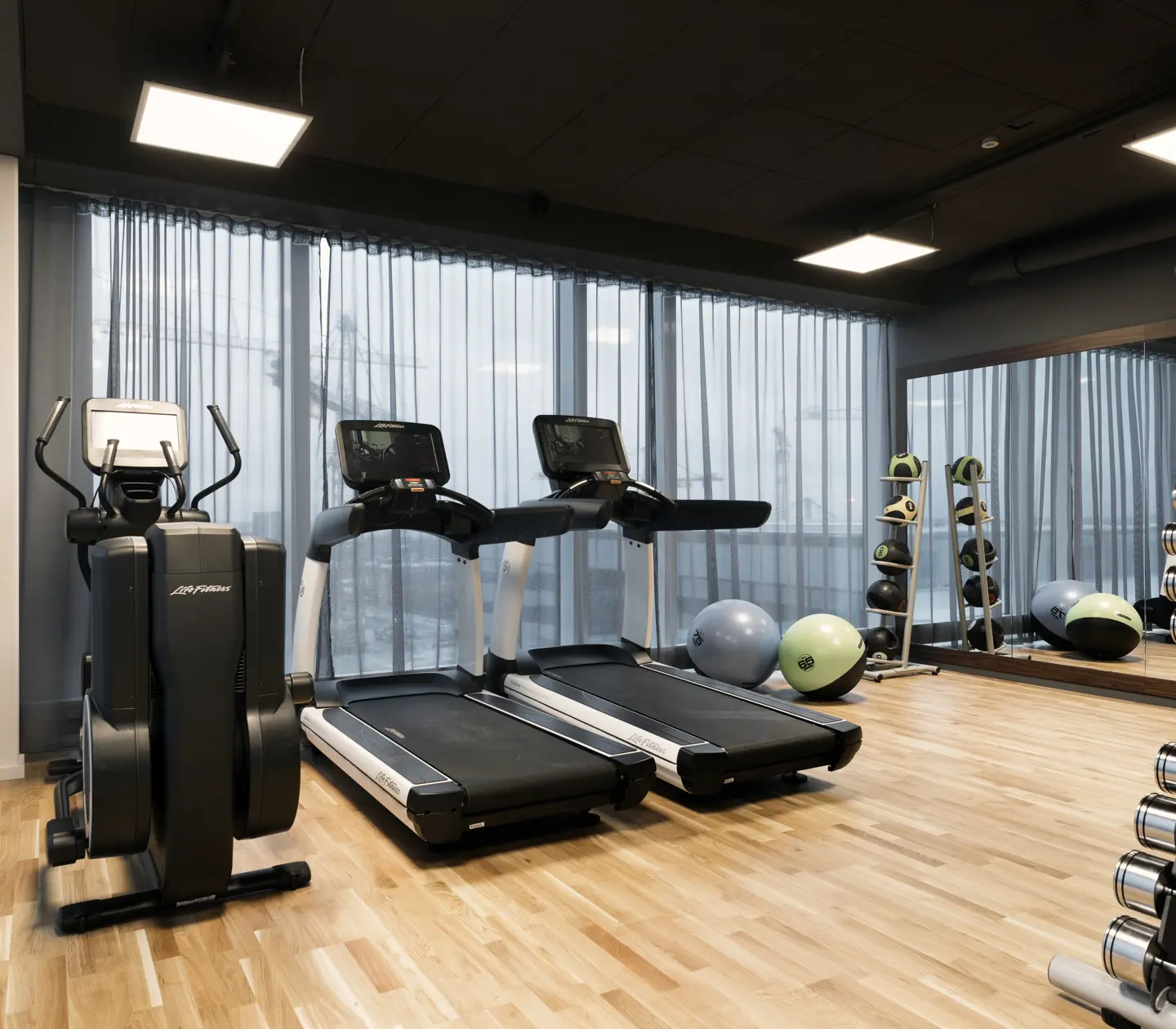 Gym environment with treadmills, dumbbells and curtains