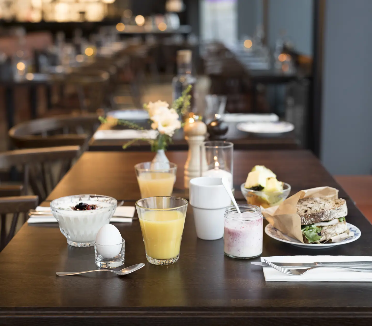 Breakfast served on a table with several food groups in the background