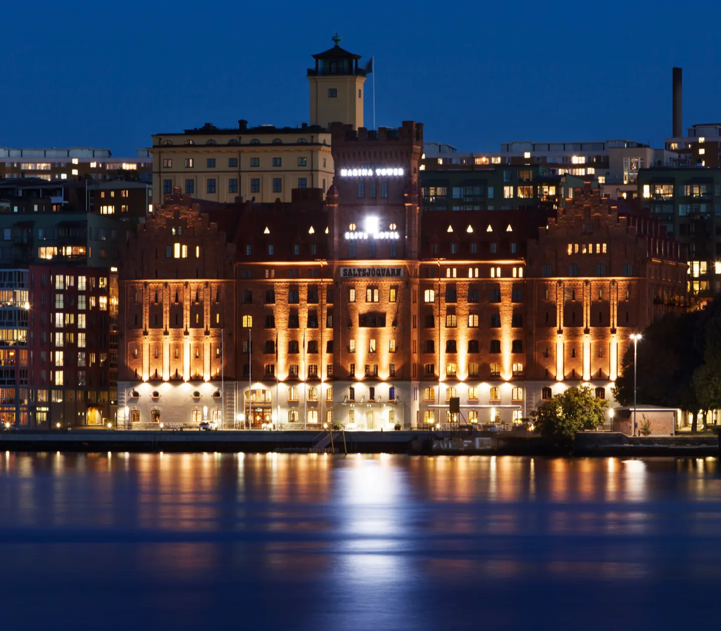 The imposing mill building of the Elite Hotel Marina Tower at dusk