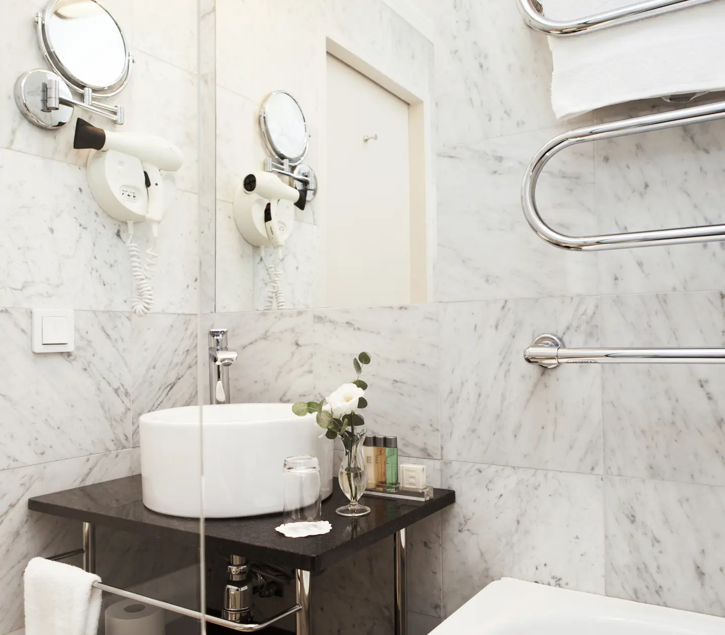Bright bathroom with heated towel rail, sink and mirror
