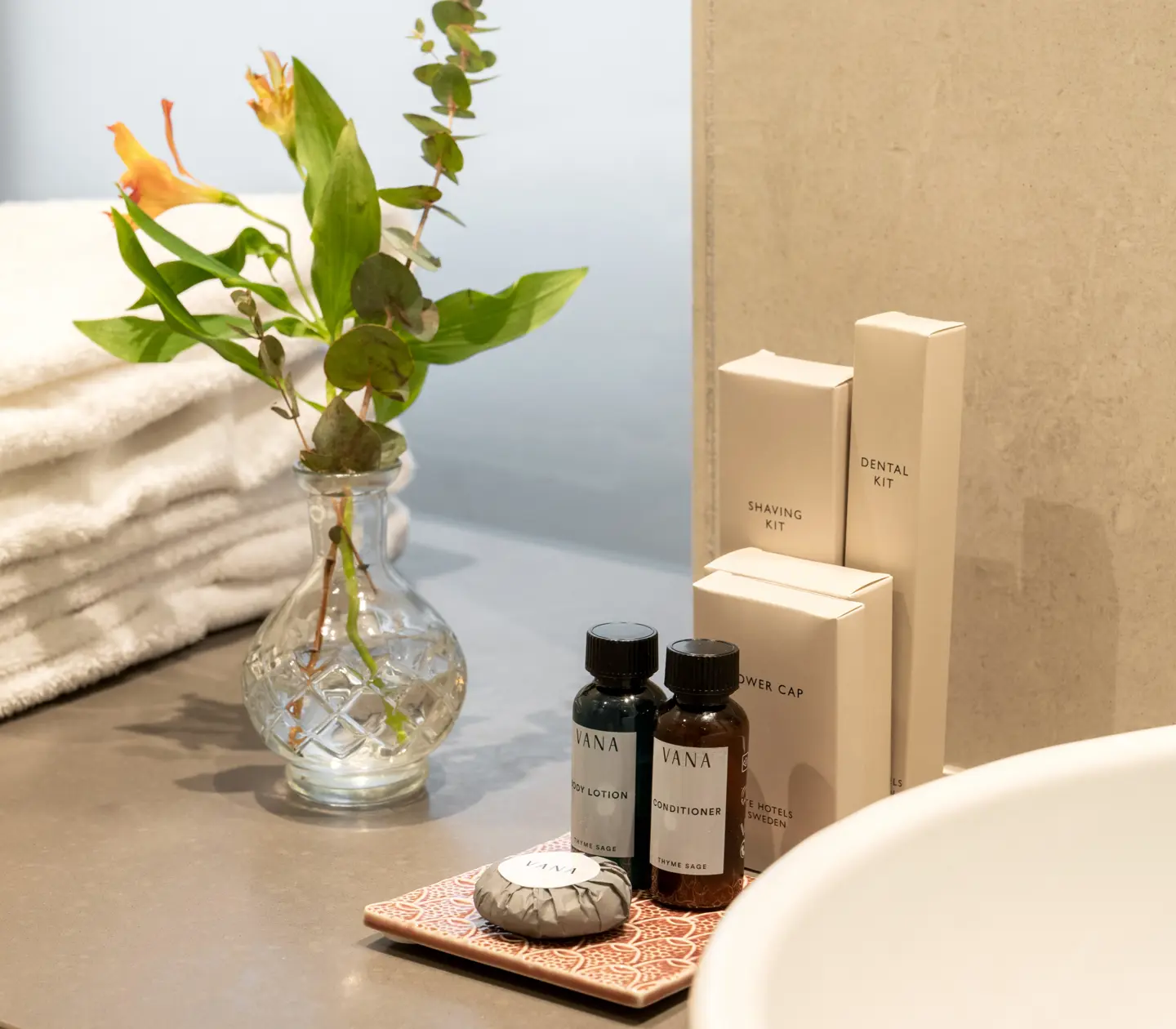 Bathroom details on sink, flower and towels