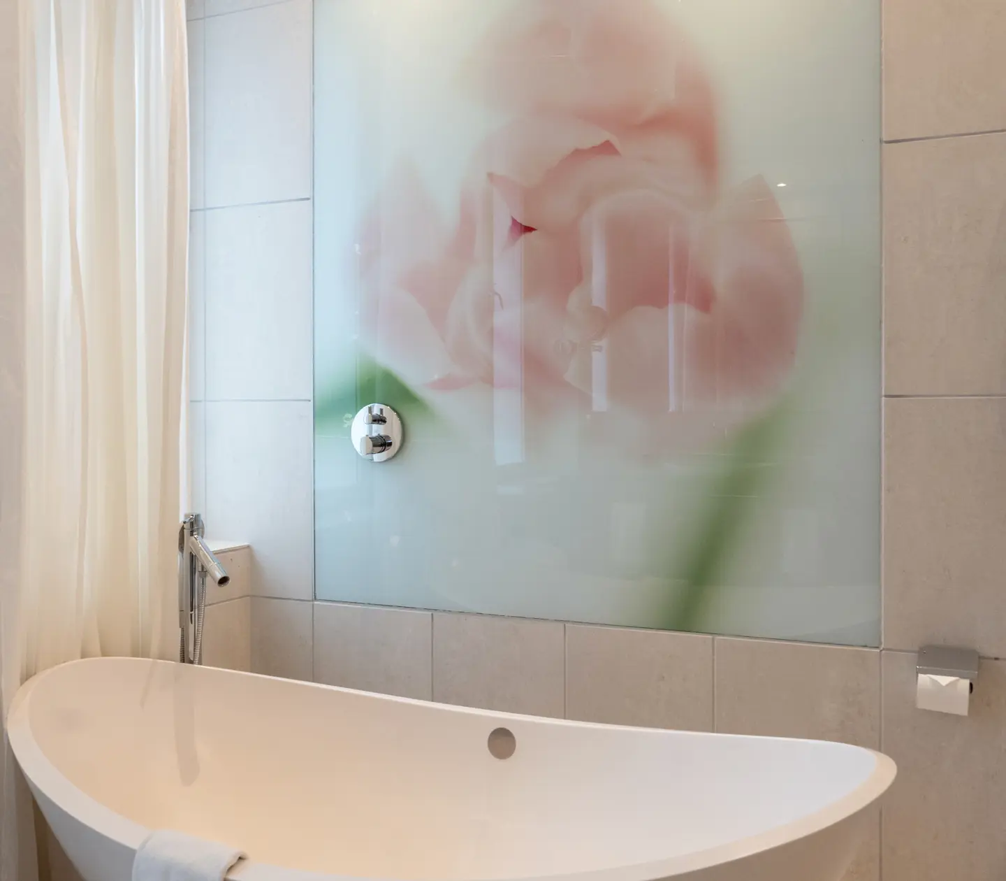 Bright bathroom with egg-shaped bathtub and painting