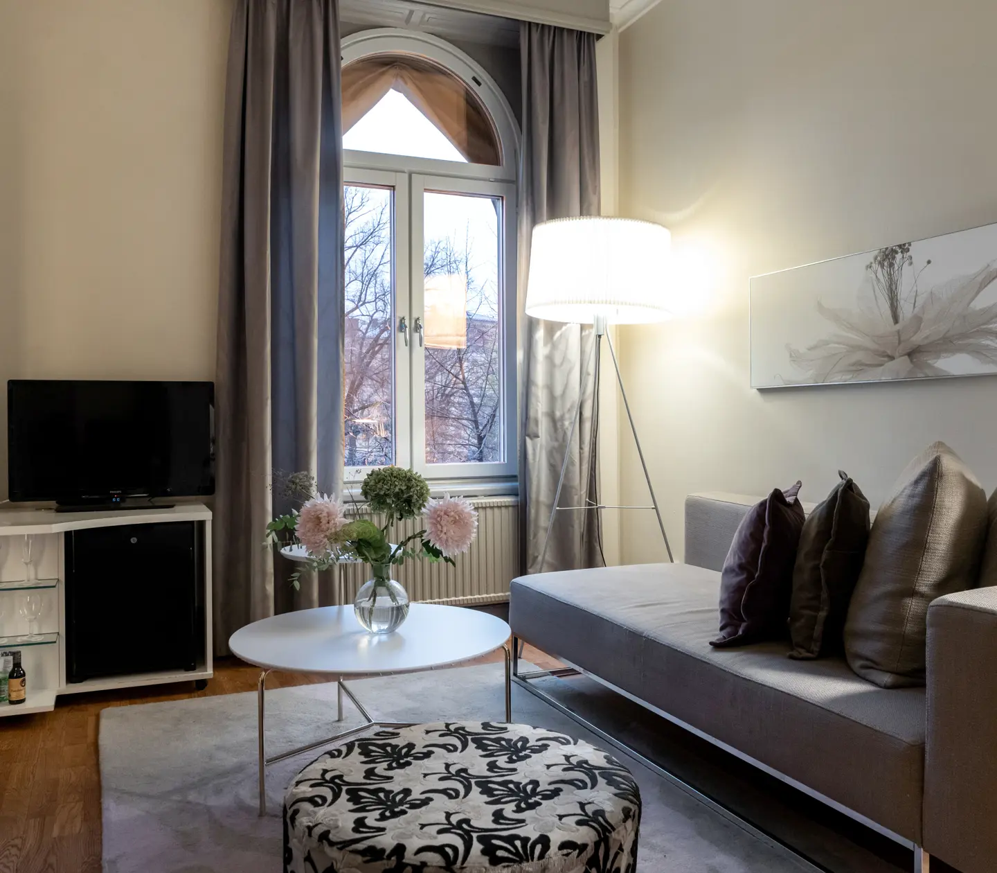 Hotel suite sofa, TV, lamps and large window