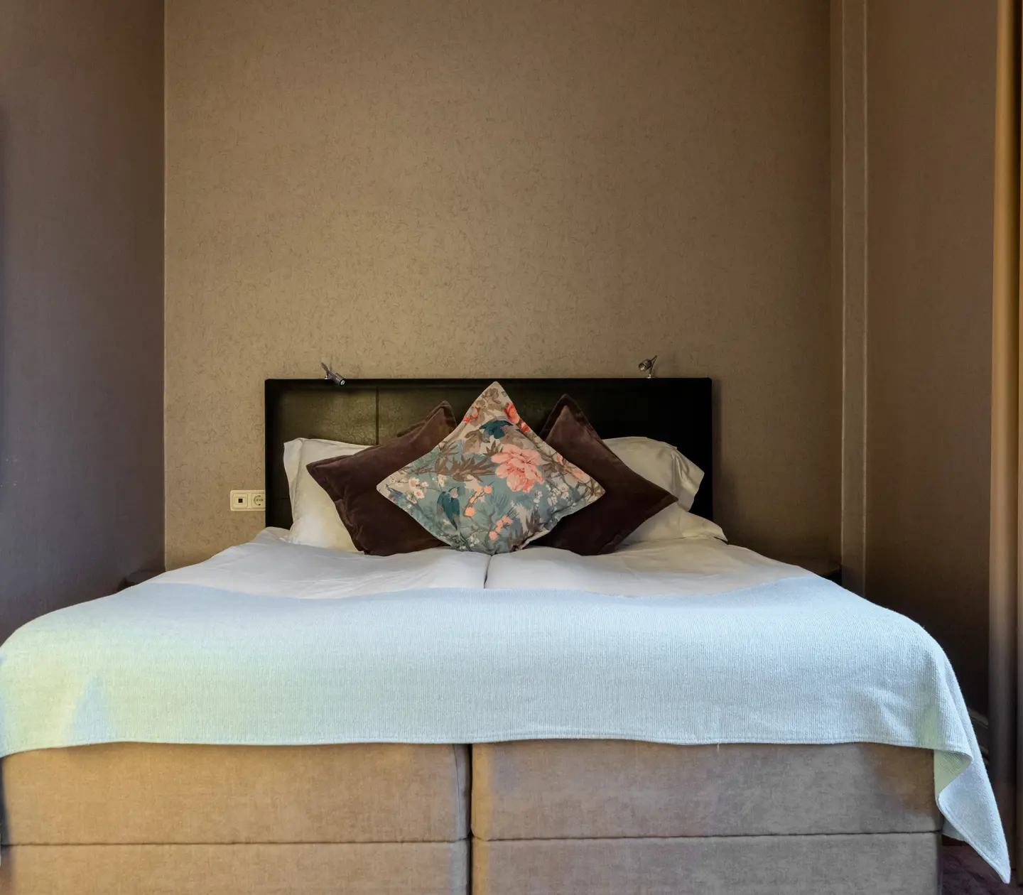 Furnished suite with double bed and painting