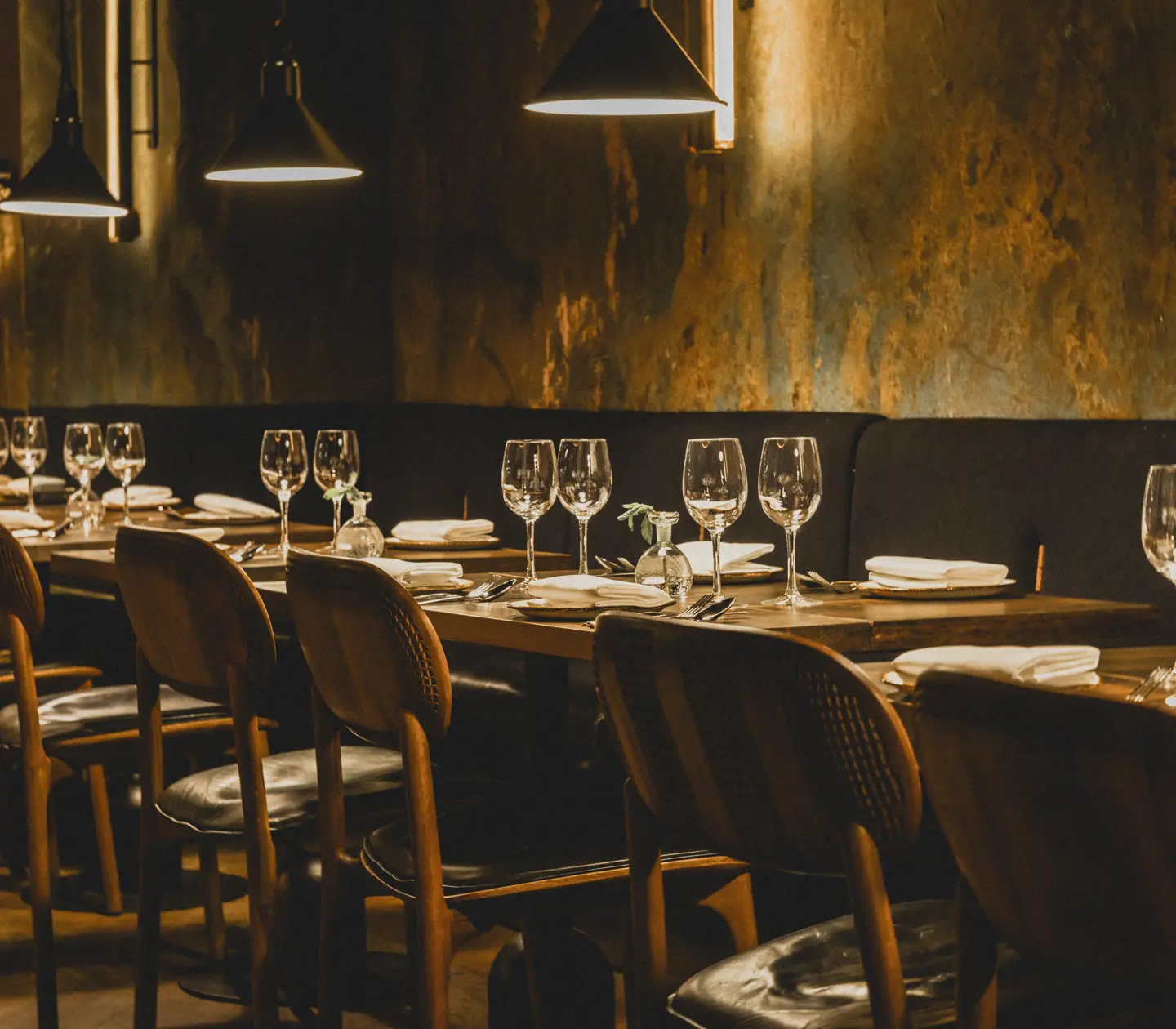 Cozy restaurant environment with many small tables and ceiling lights