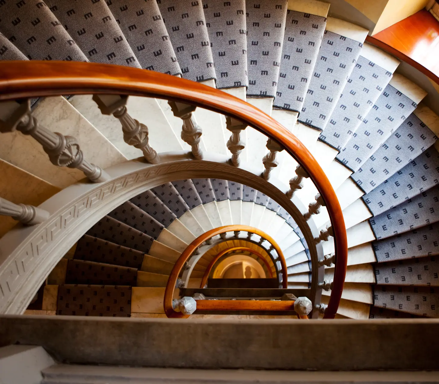 Spiral staircase shot from above with classic gray Elite carpets in the middle of the steps