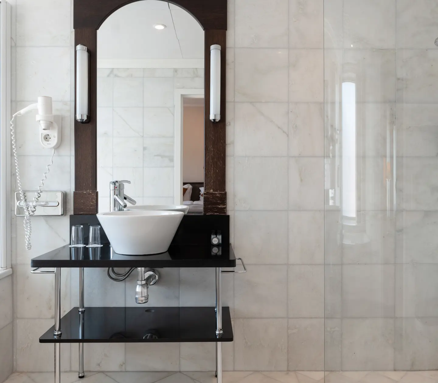 Sink with oblong mirror and wooden chest of drawers