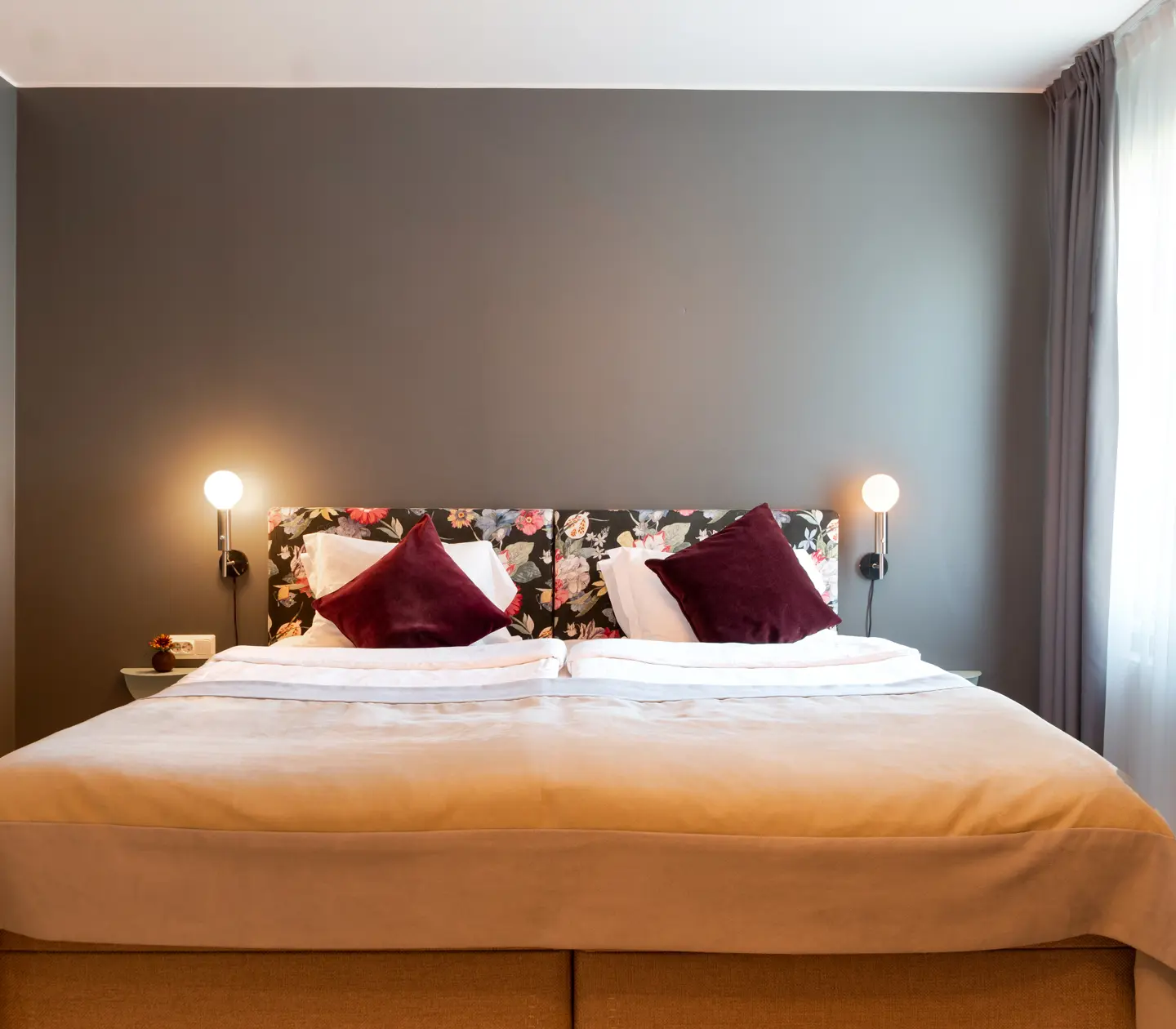 Double bed with lit wall lamps