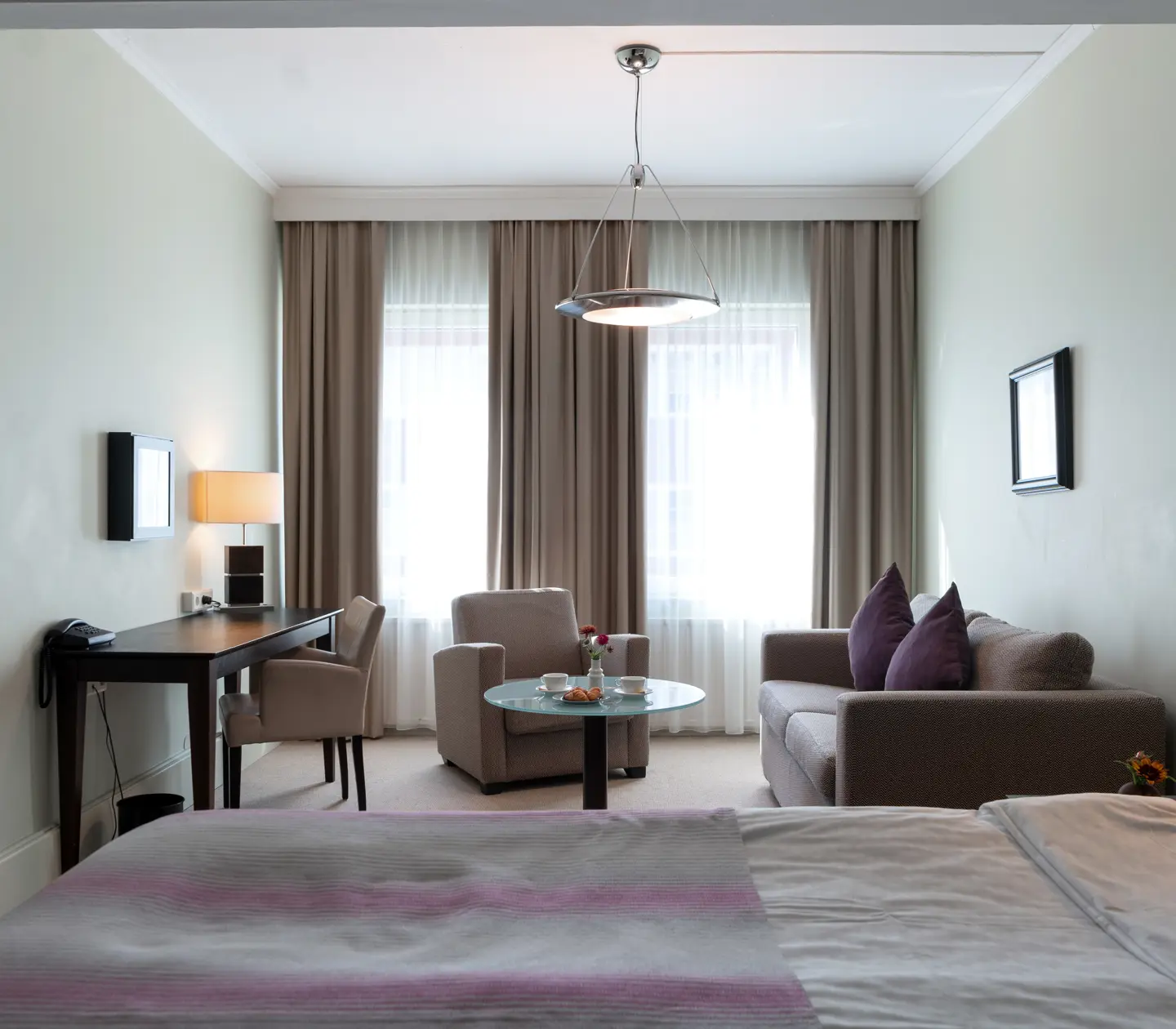 Lounge area facing window in hotel room