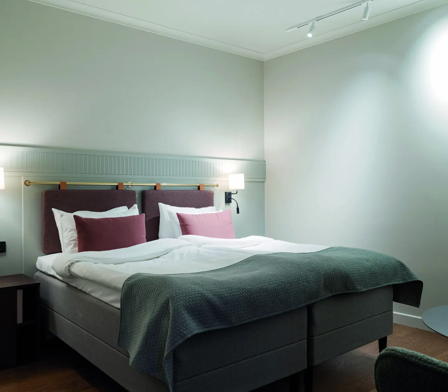 Double bed in a nicely lit room