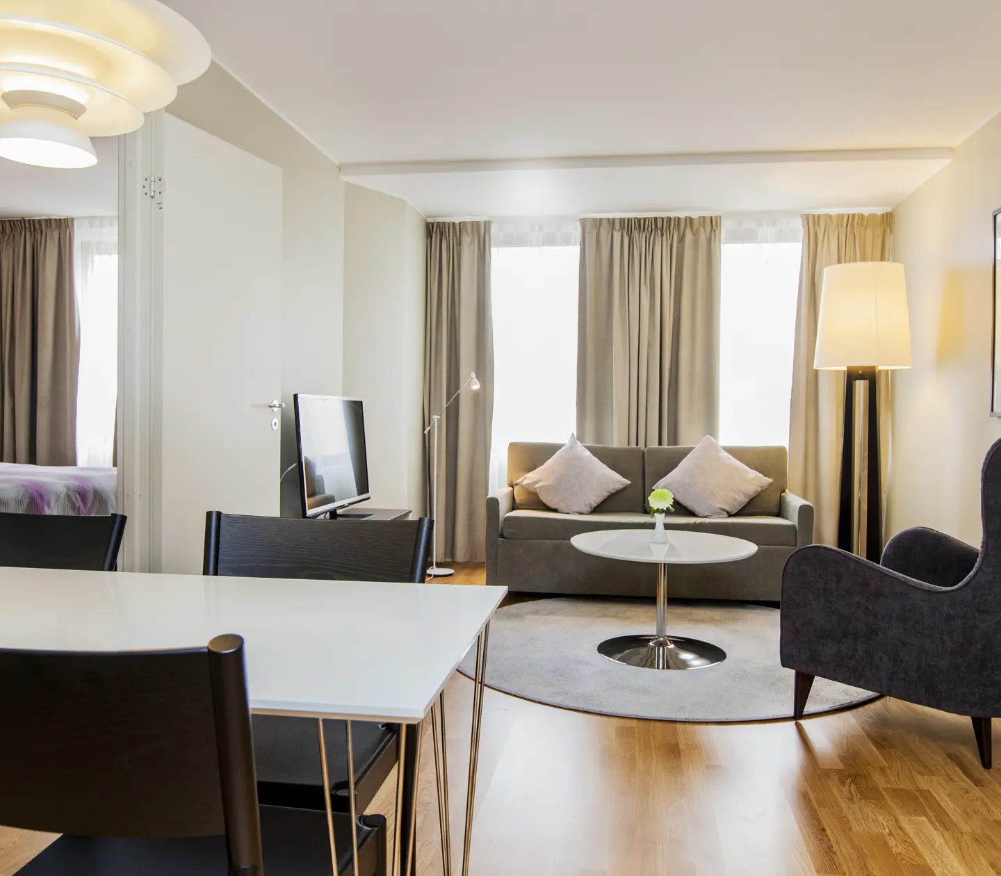 Table with chairs and lounge area facing the window