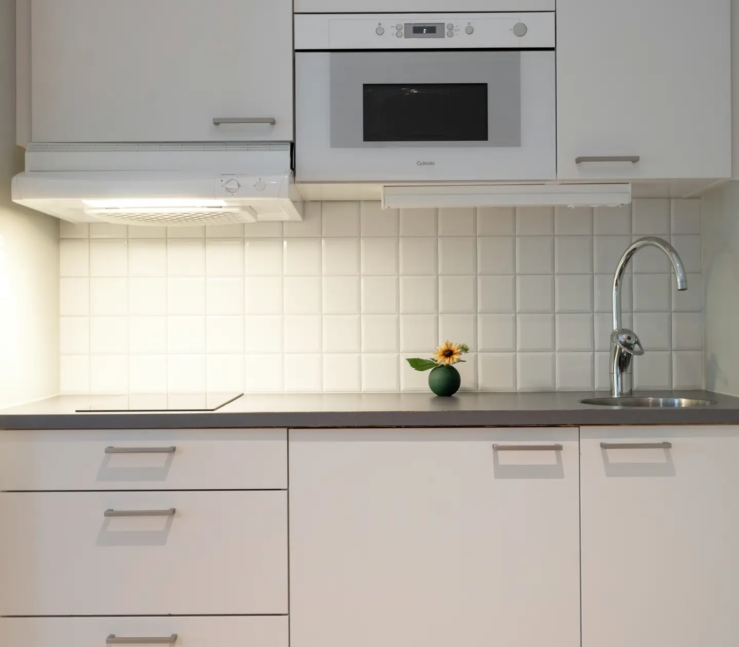 Part of kitchen with sink and white cabinets