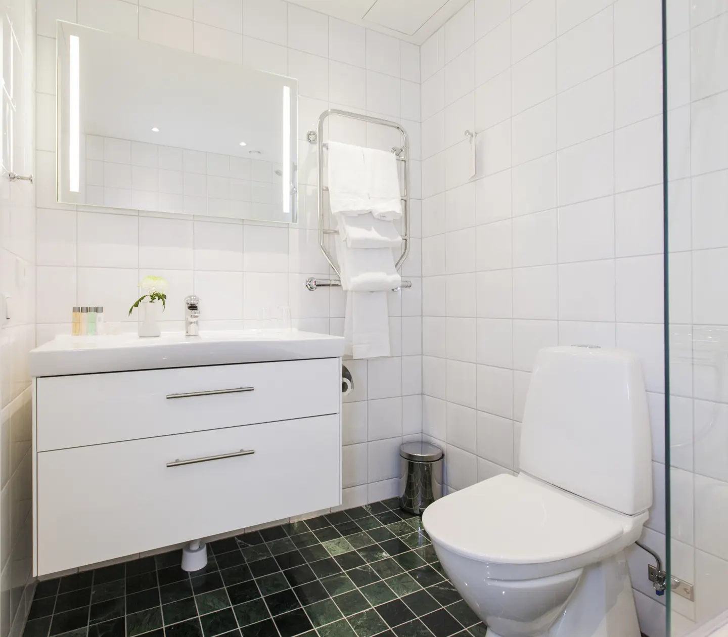 Sink with white drawers and toilet and bathroom