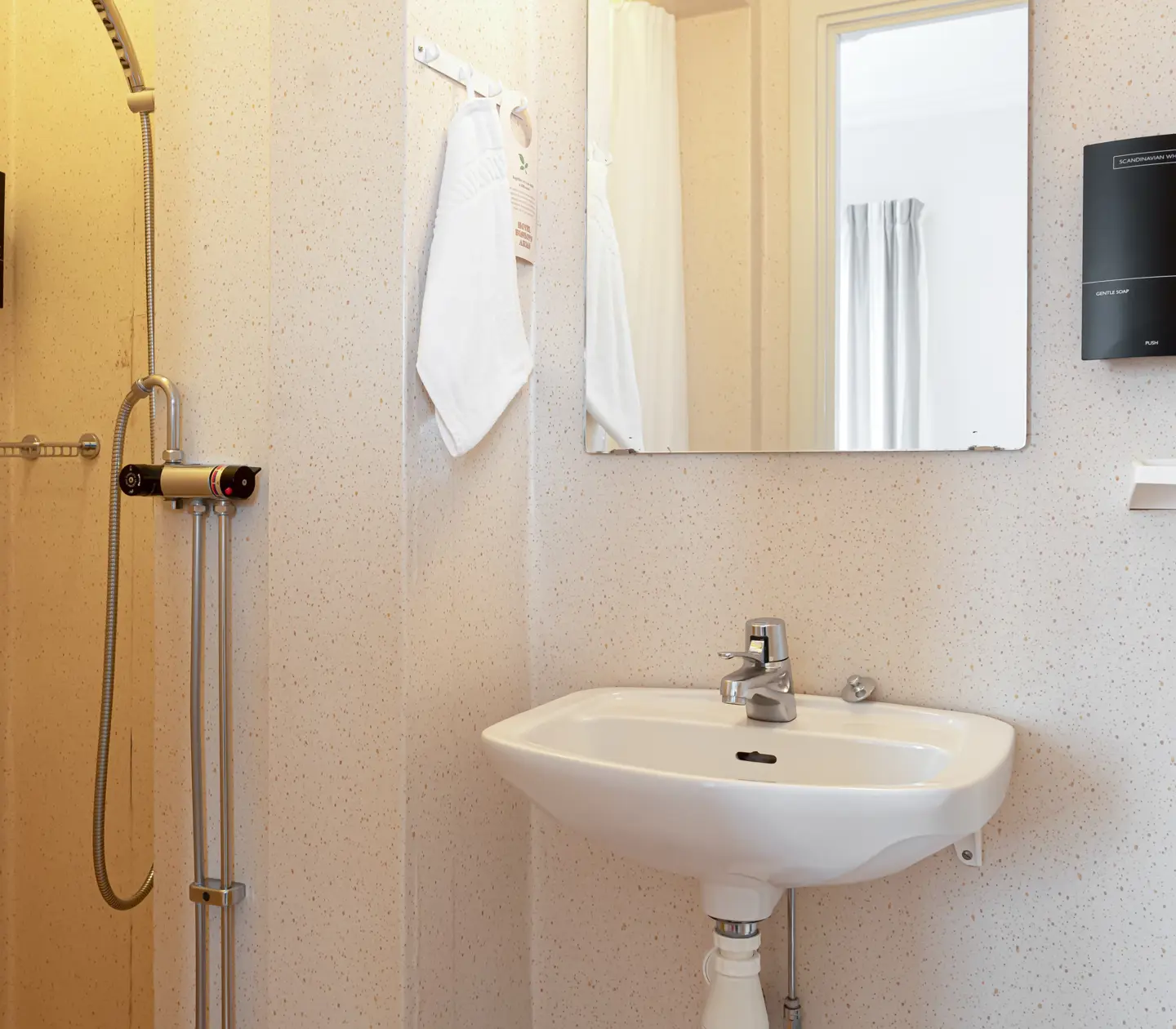 Bright bathroom with shower, sink and mirror
