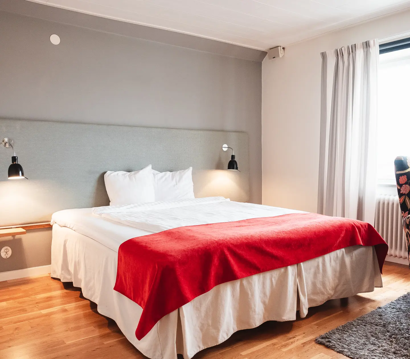 Cozy hotel room with bed, armchair and window