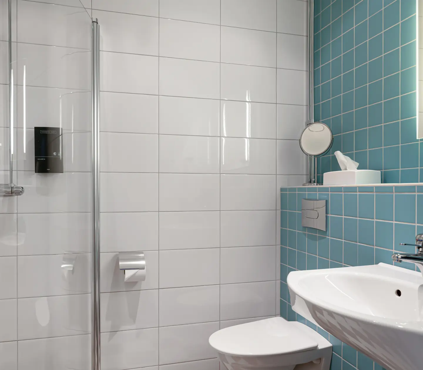 White and blue bathroom with toilet, sink and shower