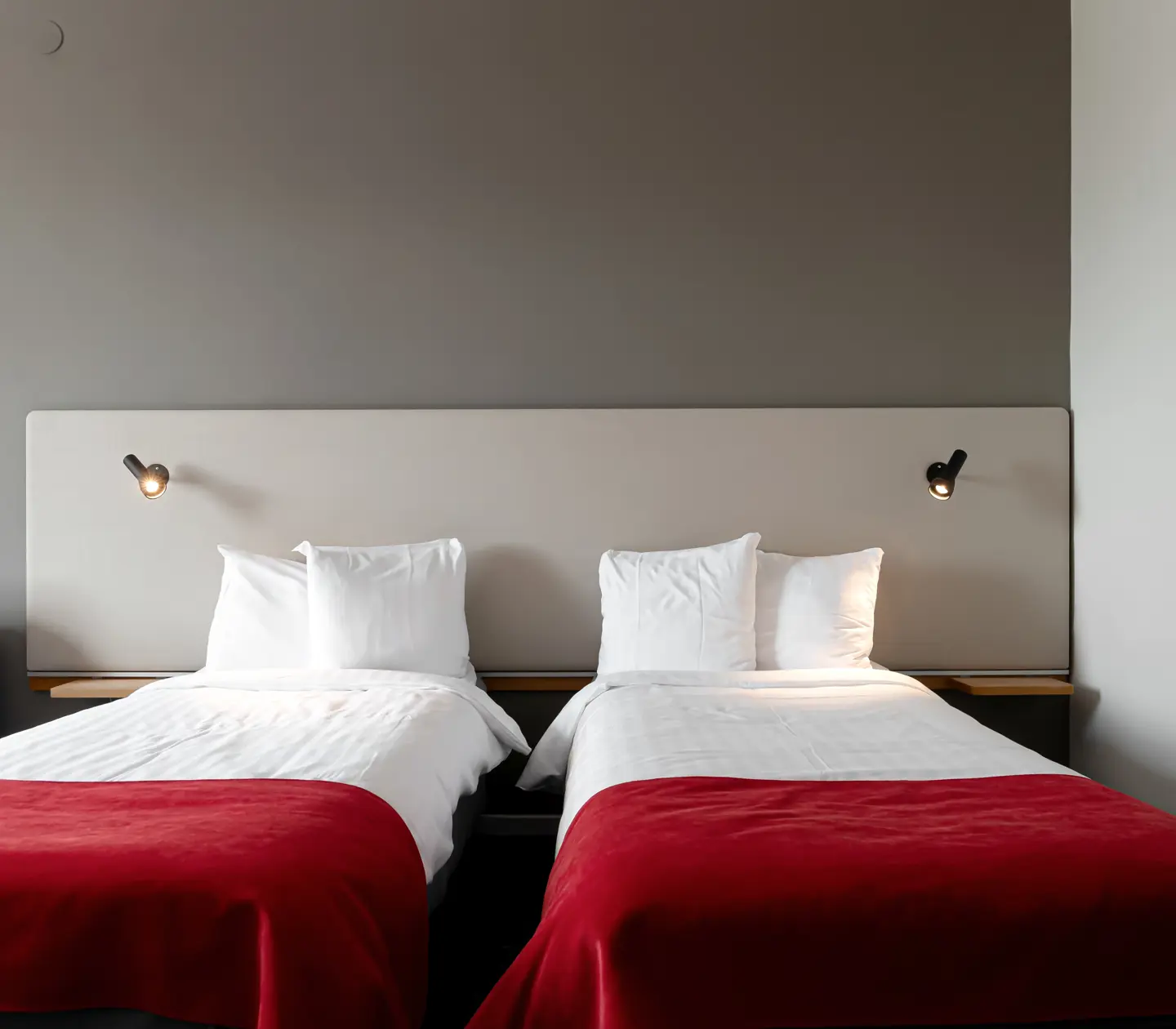 Cozy hotel room with beds, pillows and bedside lamps
