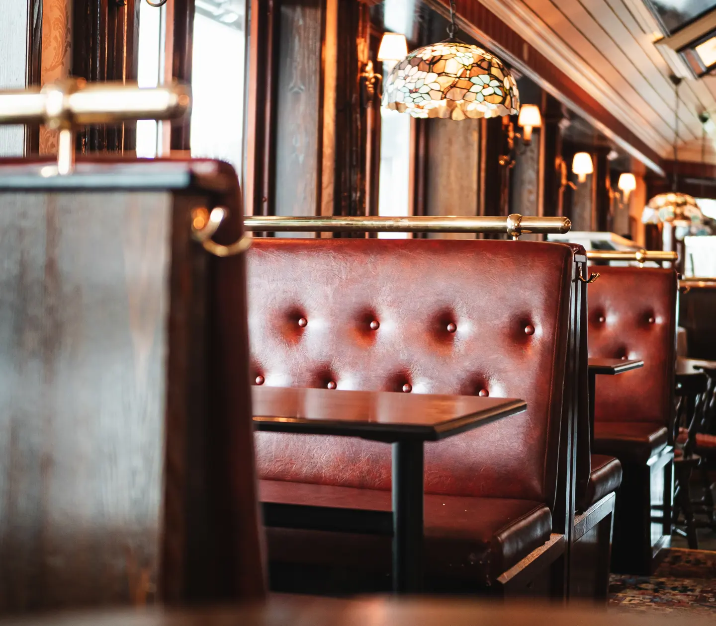 Pub environment with seating, windows and ceiling lights