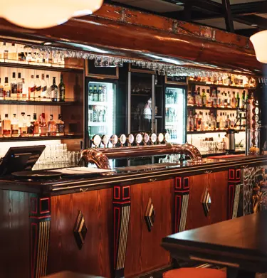 Pub environment with bar counter, glasses and bottles