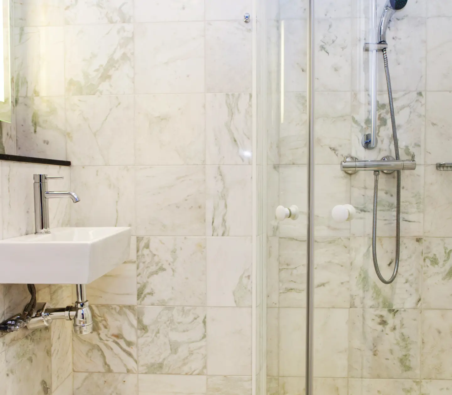 Bathroom with sink, shower and mirror