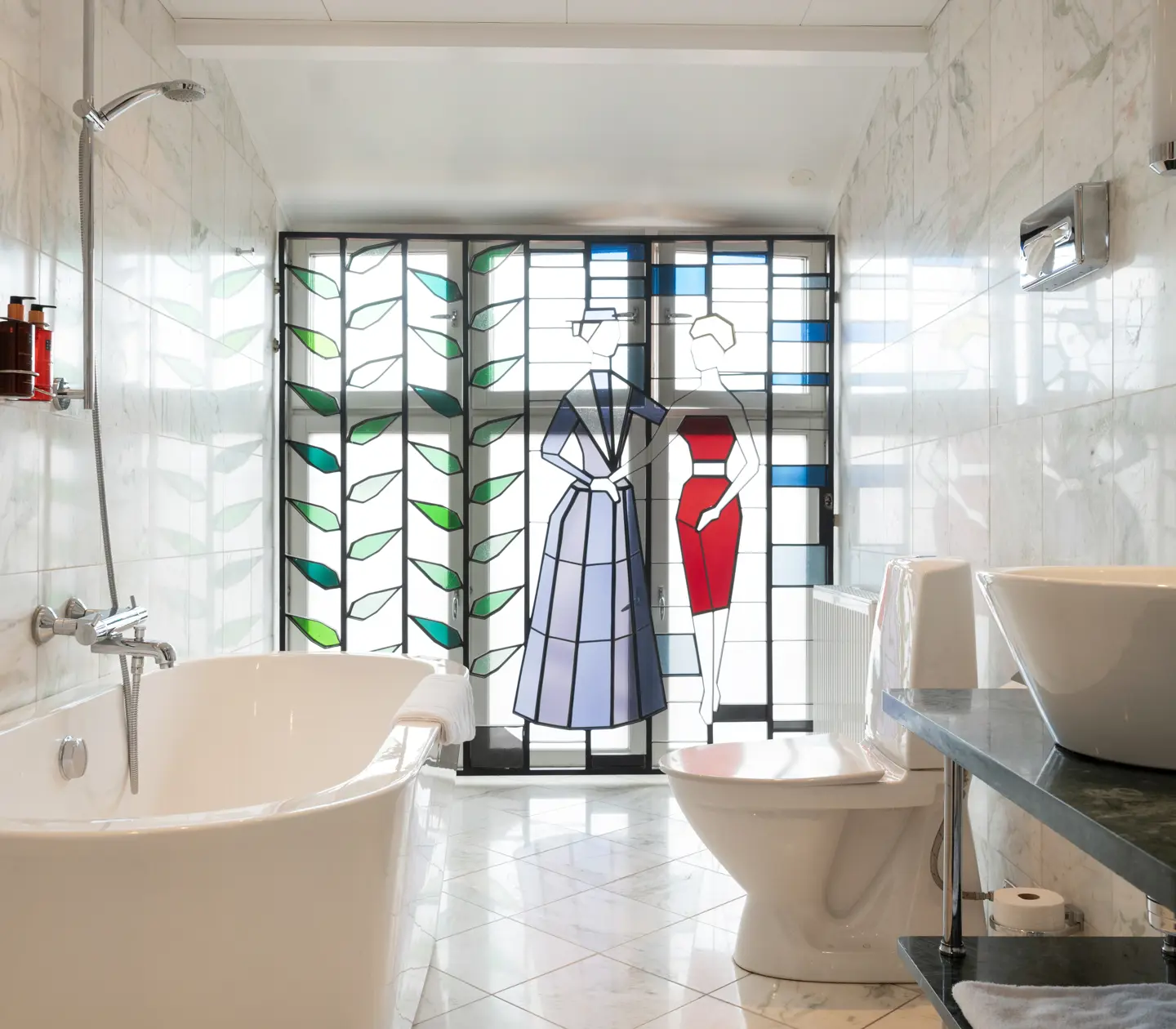 Bright bathroom with bathtub, toilet and painting on glass