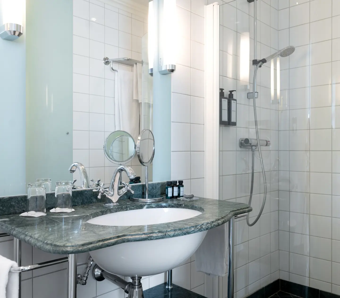 Bright bathroom with shower, green sink and mirror