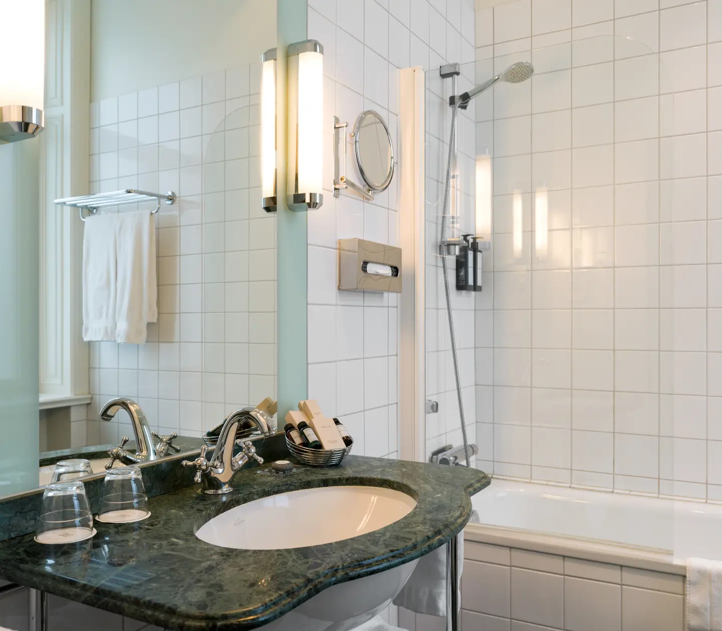 Bright bathroom with bathtub, green sink and mirror