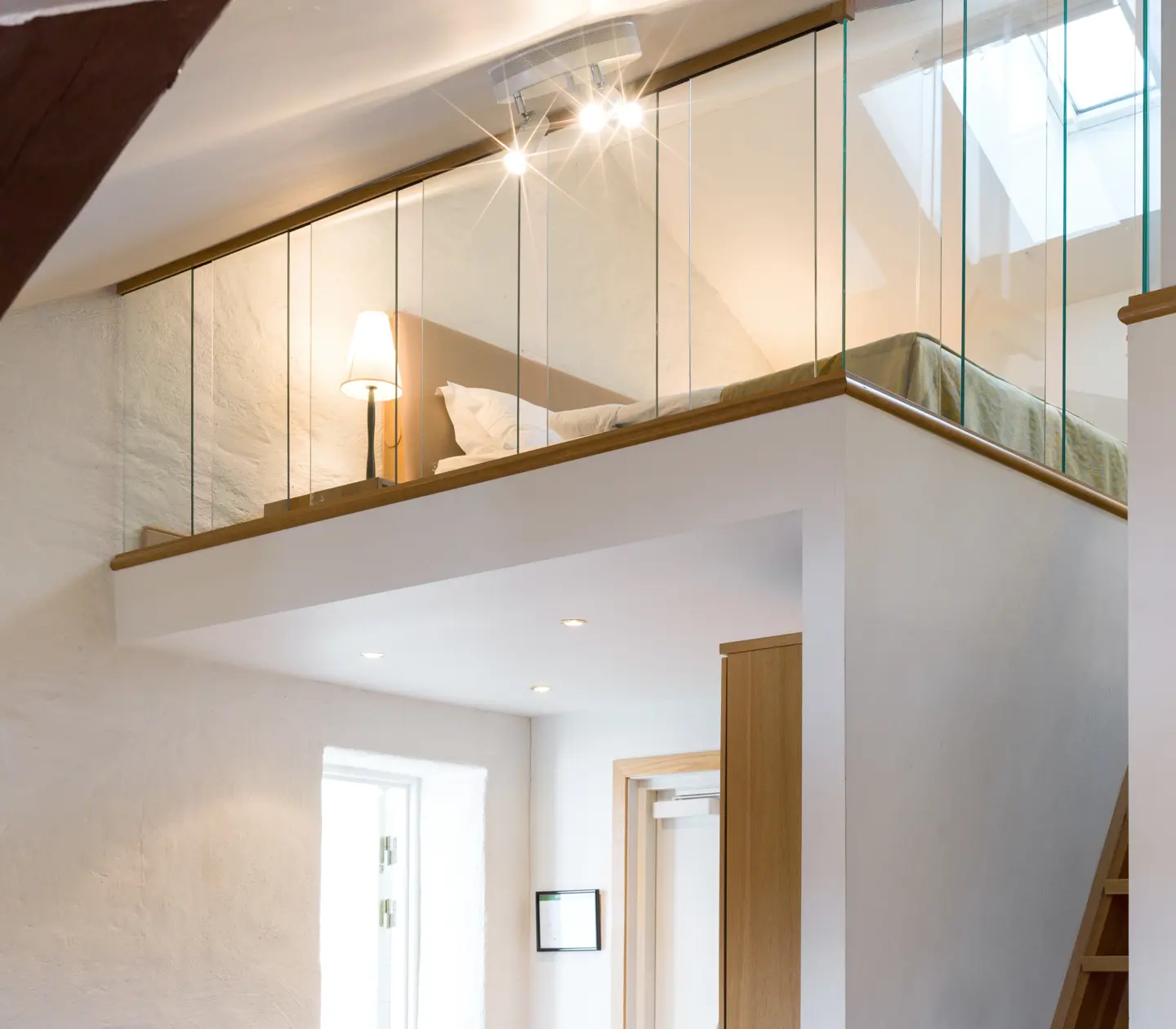 Bright suite with bed, sleeping loft and glass railing