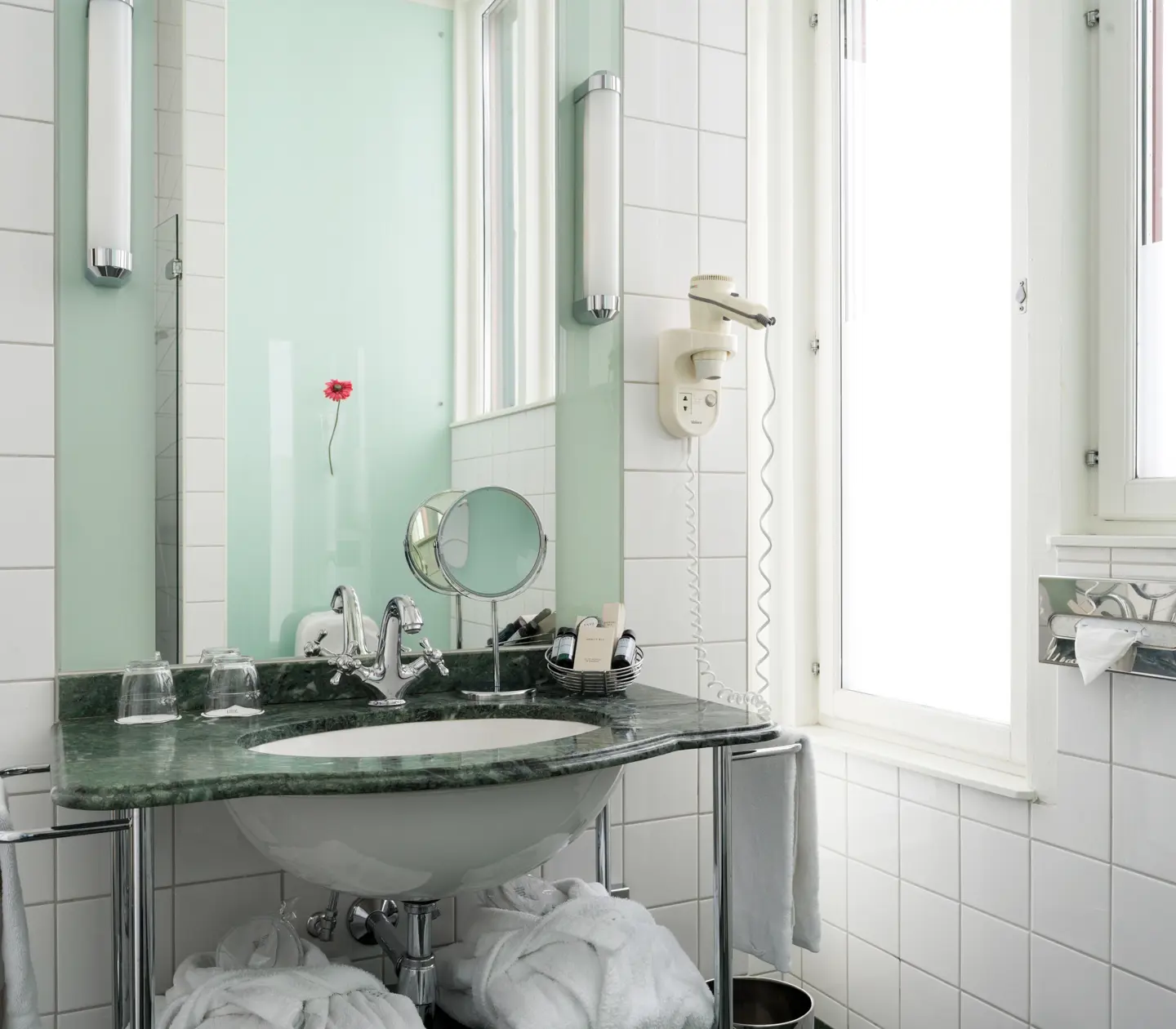Bright bathroom with window, green sink and mirror