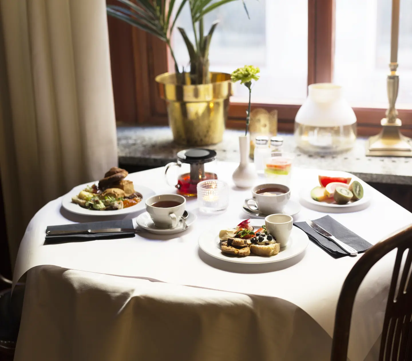 Breakfast served at a round table in front of the window