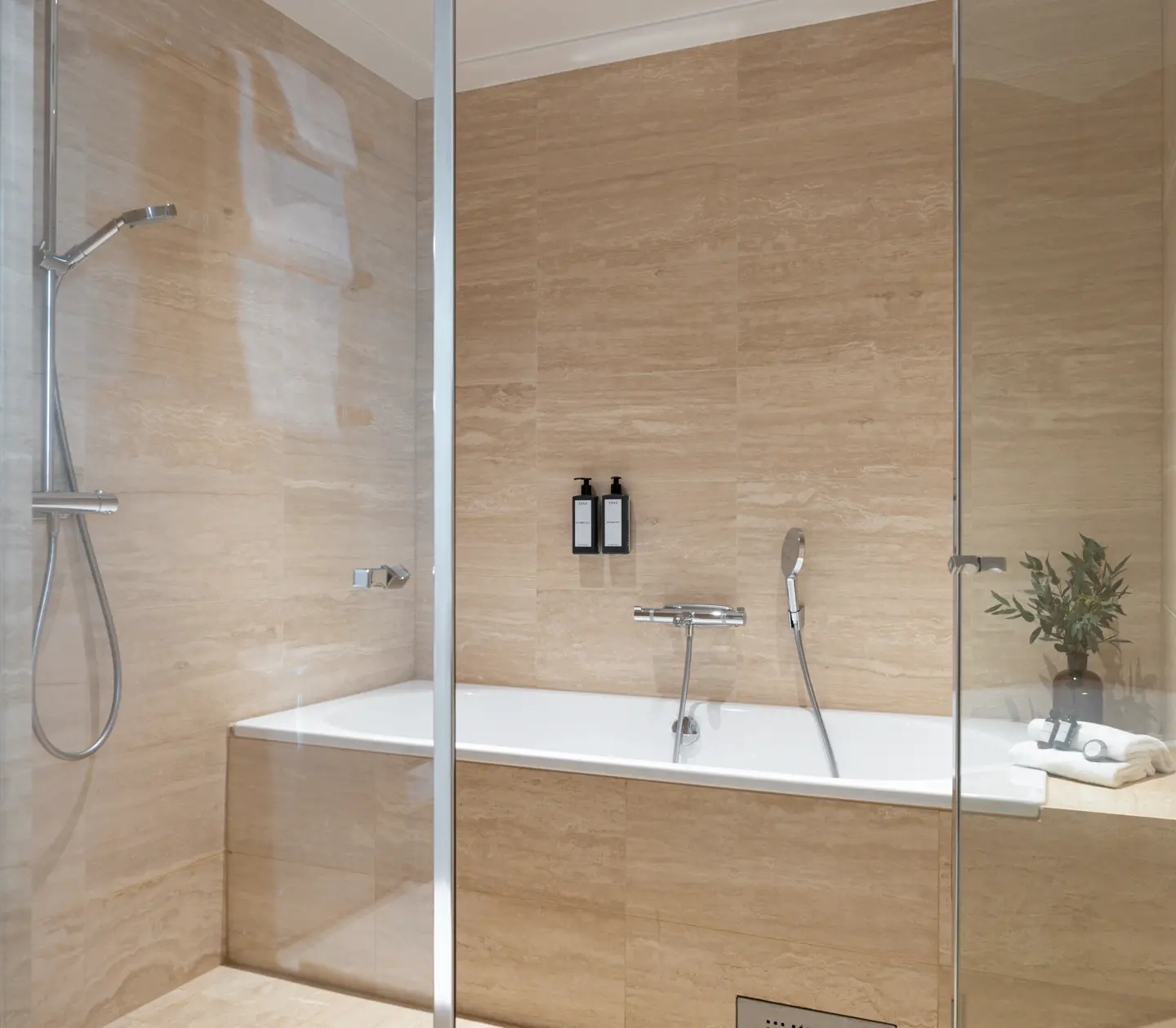 Beige bathroom with bathtub, shower and flower