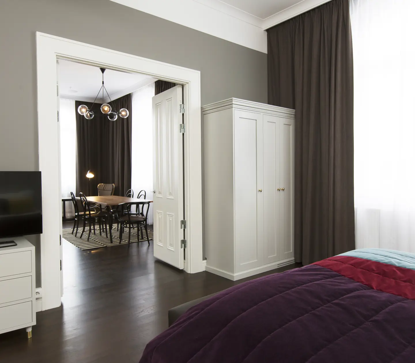 Bright suite with large windows, dining area and wardrobe