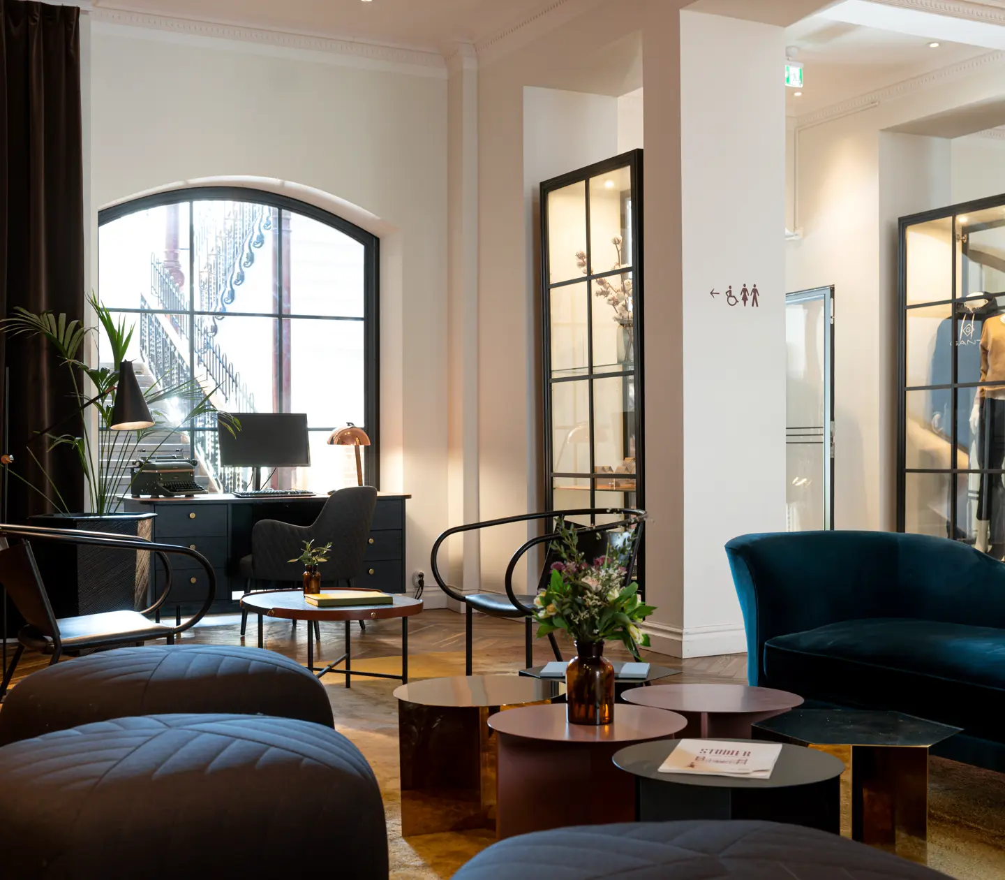 Hotel lobby with flower bouquet, lounge furniture and desk