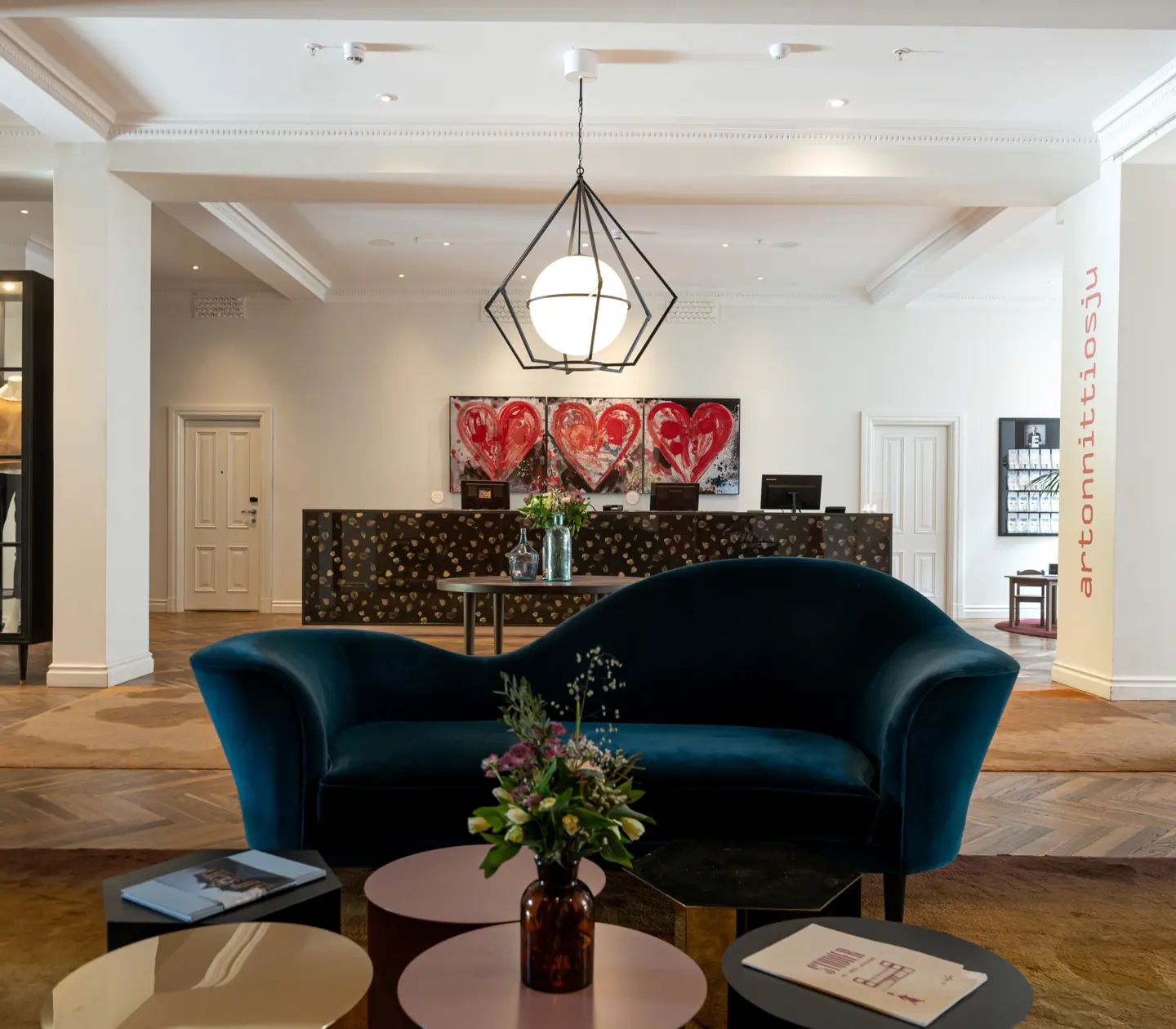 Hotel lobby with flower bouquets, lounge furniture and reception desk