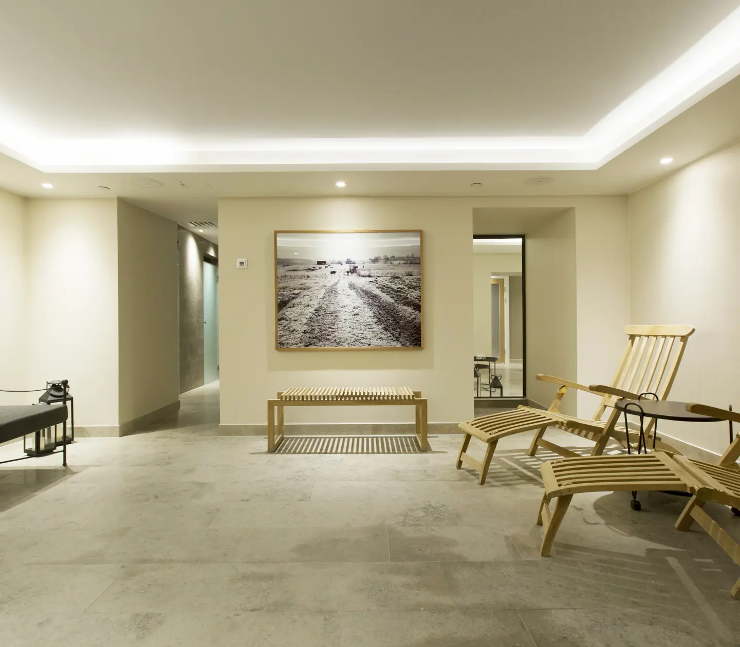 Spa environment with sofa, sunbeds and blackboard