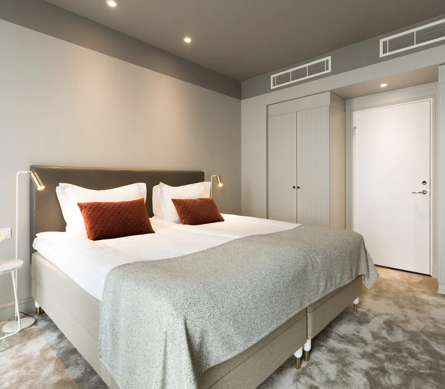 Suite with bed, wardrobes and cozy carpet
