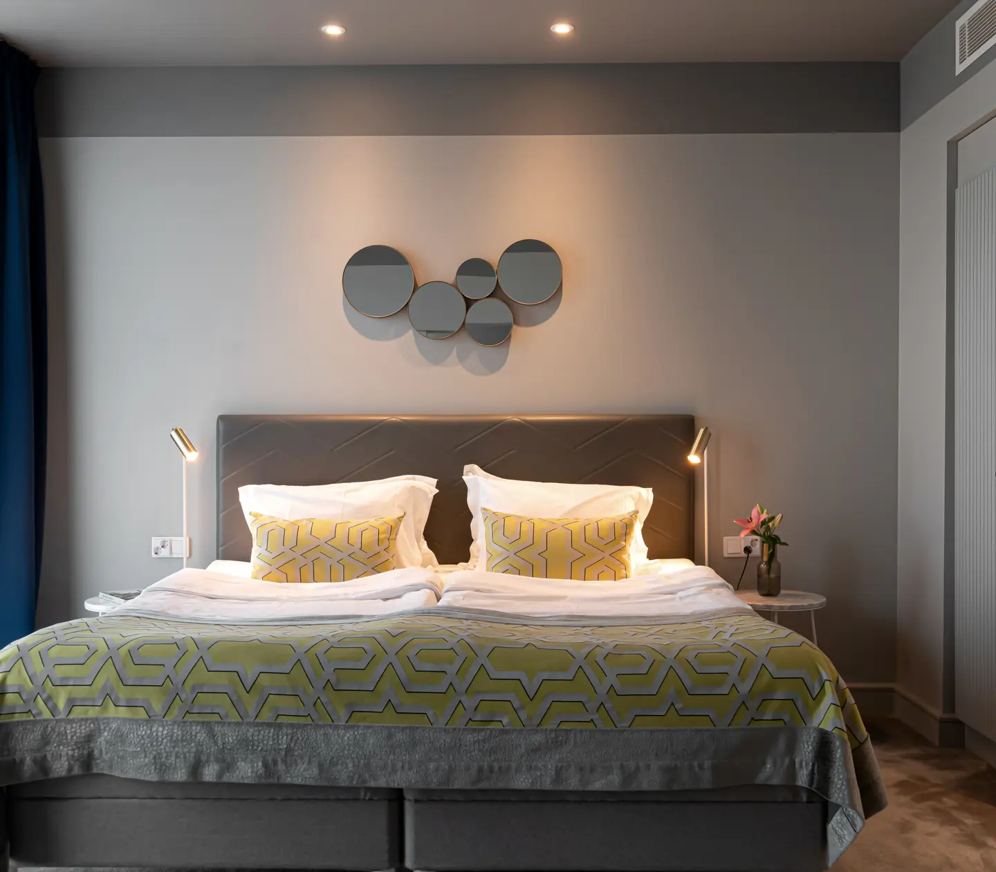 Cozy suite with bed, wardrobe and mirror