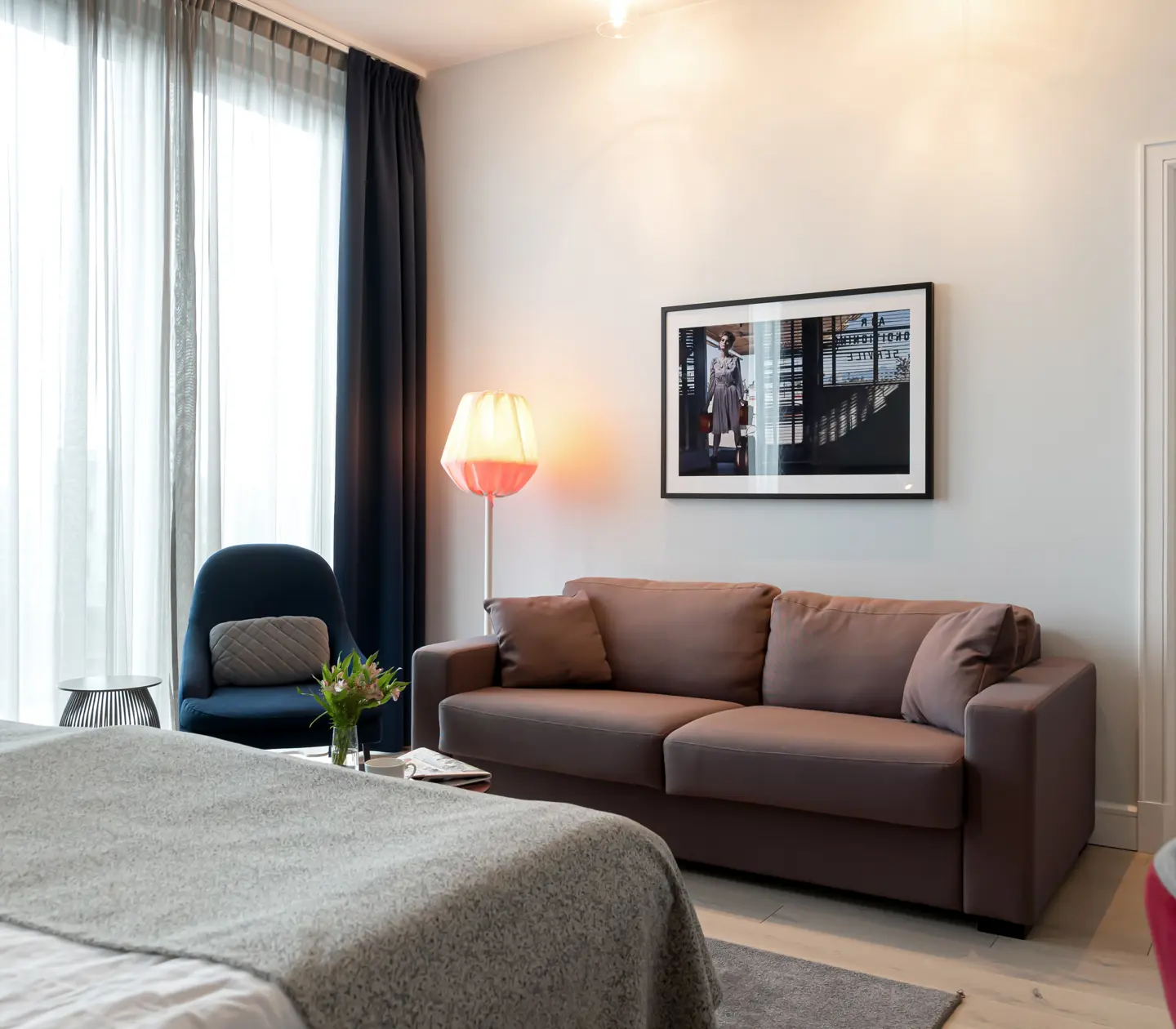 Cozy suite with sofa, armchair and large windows