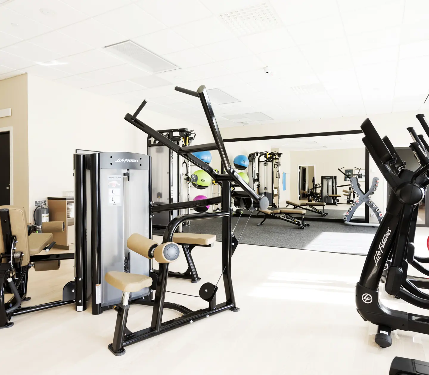 Gym environment with exercise machines, mirrors and medicine balls