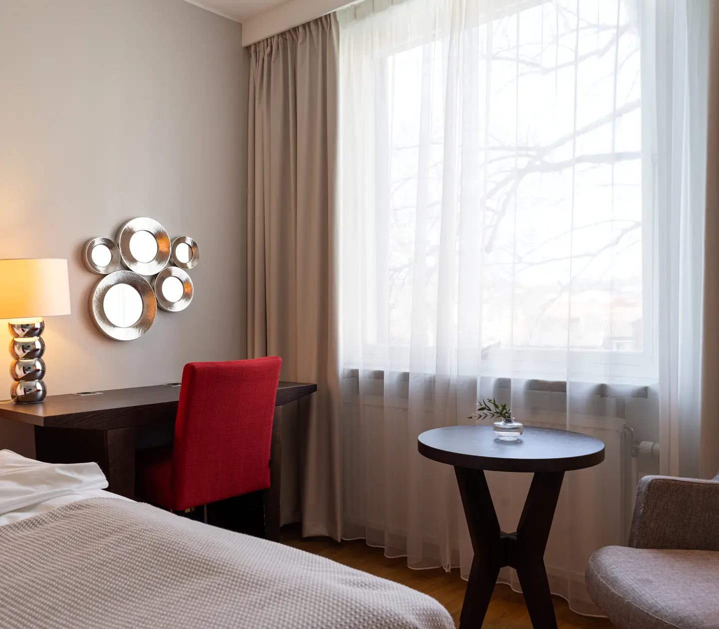 Hotel room with marble pillars, window and armchair