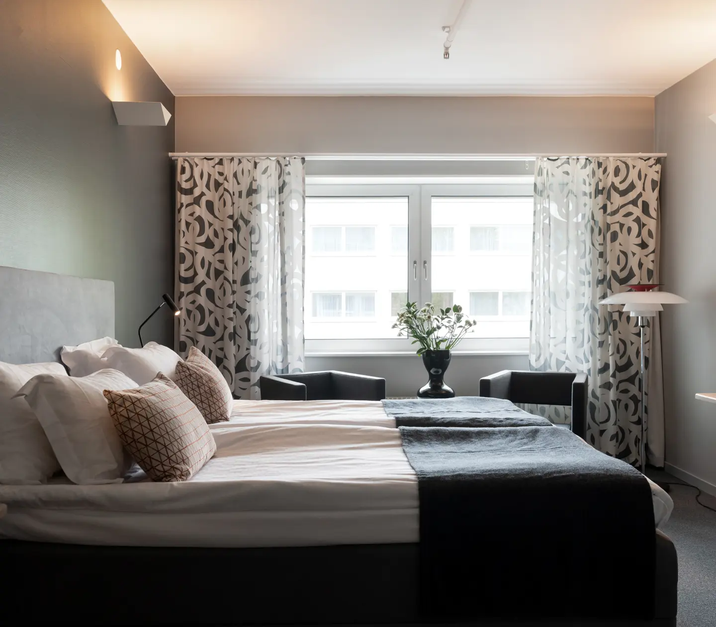 Bright hotel room with double bed, desk and window