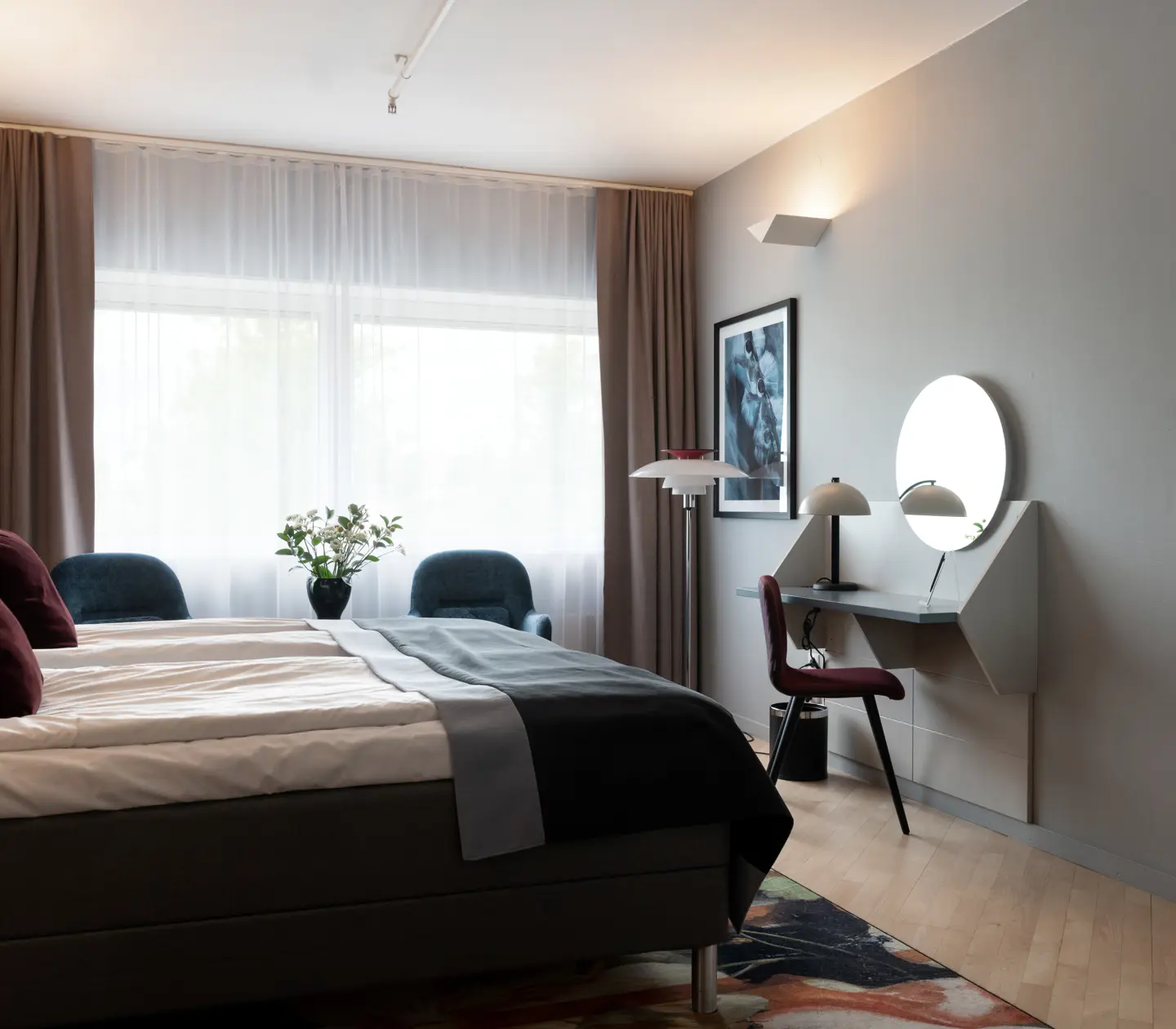 Cozy hotel room with double bed, window and desk