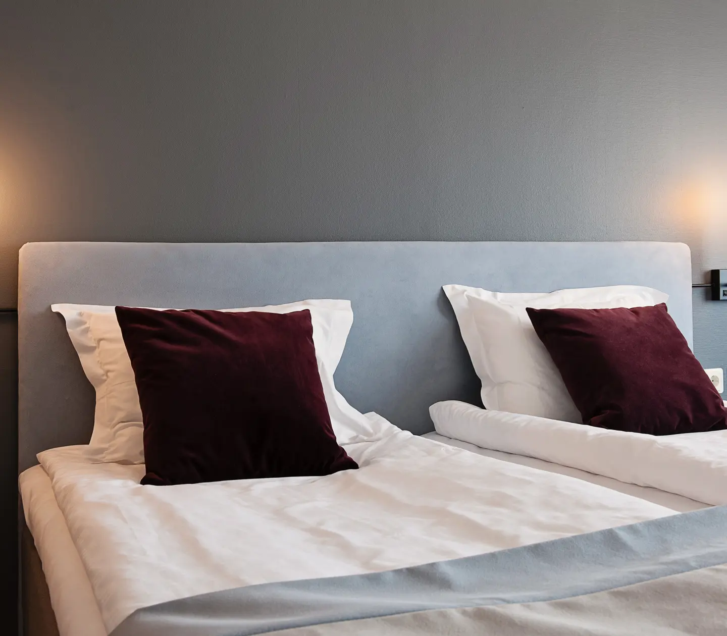 Close-up of double bed and bedside lamps