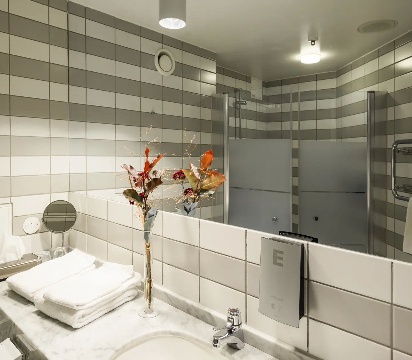 Bathroom with striped tiles, mirror and shower