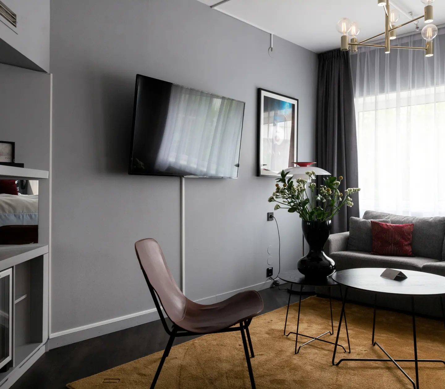 Hotel room with sofa, TV and window