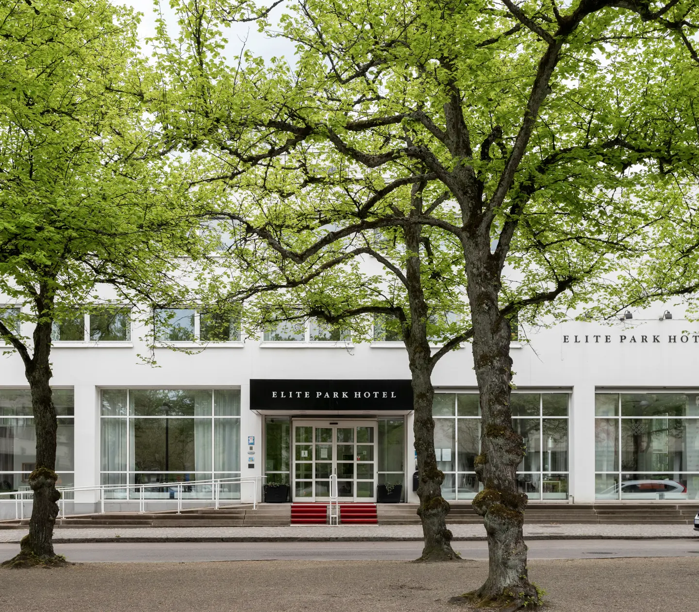 The entrance of the Elite Park Hotel with trees outside